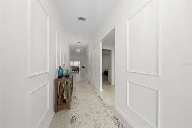 a hallway with a view of living room
