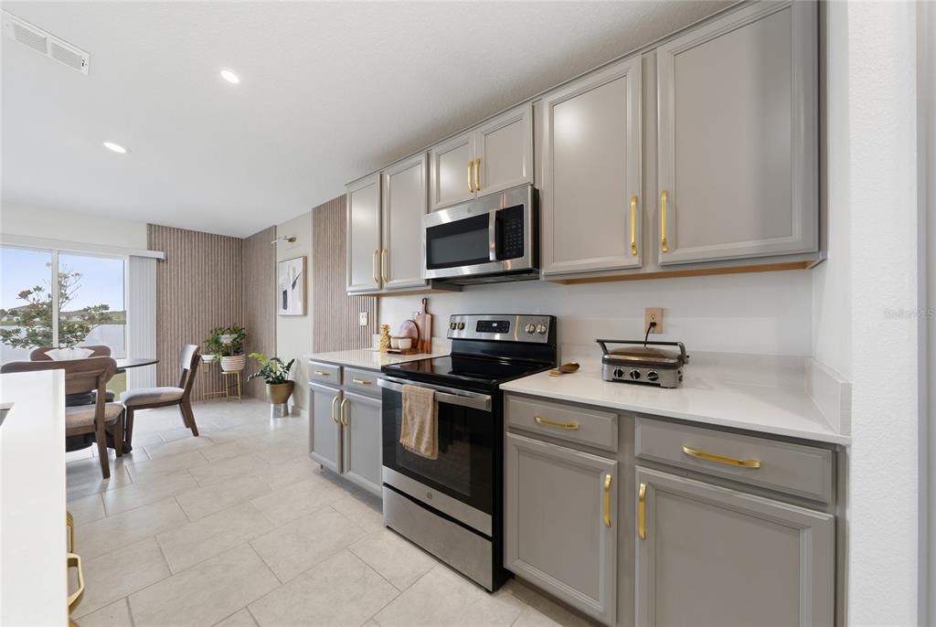 5121 Four Strand Court St. Cloud, FL 34772 - Photo 10 of 26 a kitchen with cabinets and appliances