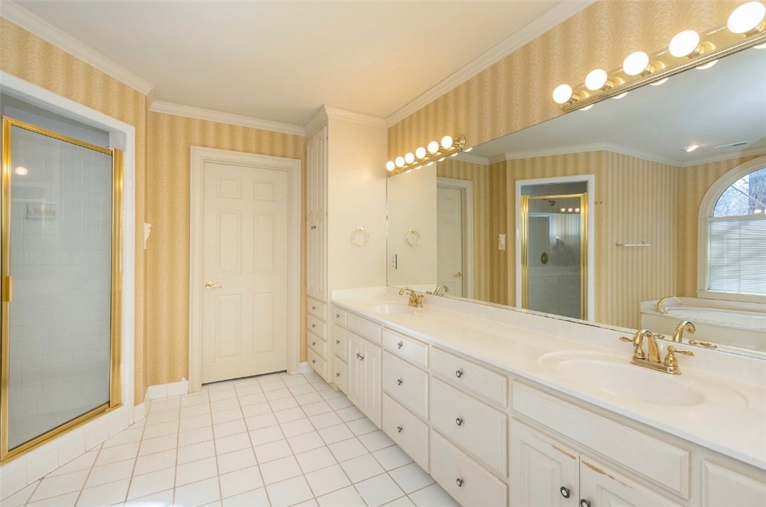 1104 Thornehill Drive Anderson, SC 29621 - Photo 31 of 35 This spacious bathroom offers a double vanity, a glass-enclosed shower, and a relaxing soaking tub.