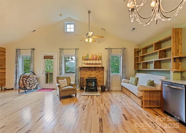 a living room with furniture a fireplace and a chandelier