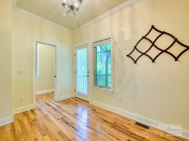 an empty room with a window and a ceiling fan