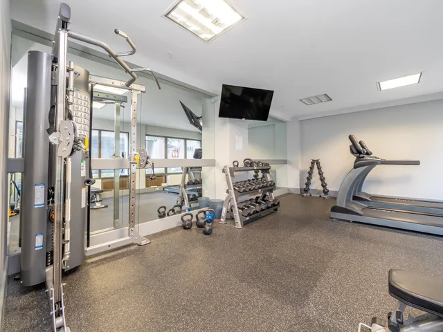 a view of a room with lots of gym equipment