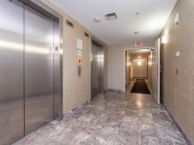 a view of a brick building with many windows