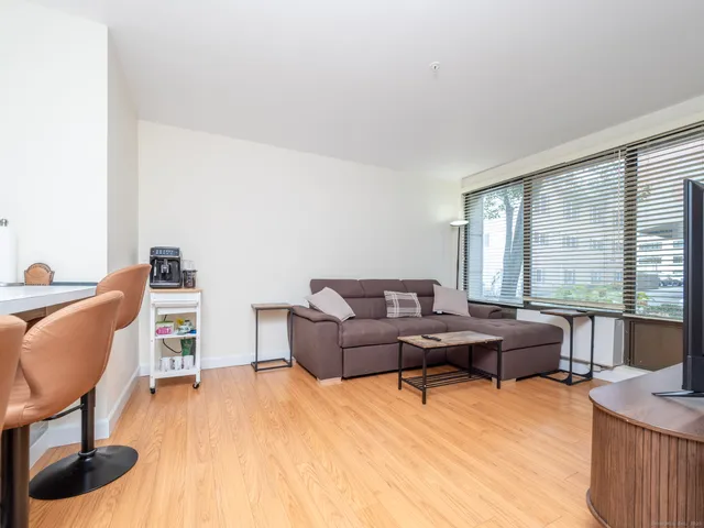 a living room with furniture and large windows