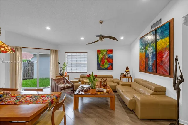 a dining room with furniture and wooden floor