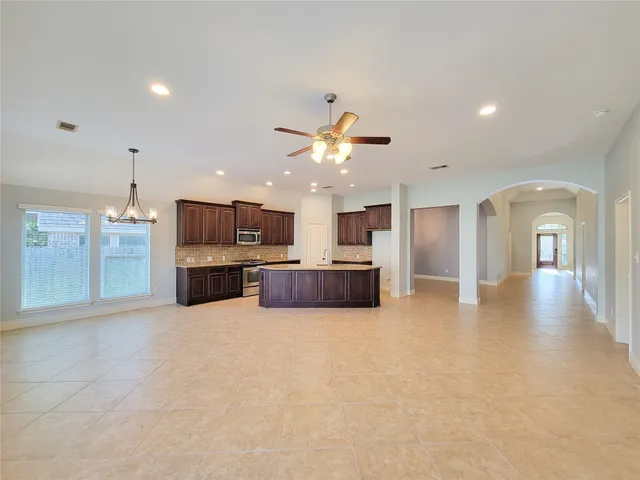 a view of kitchen with stove and cabinets