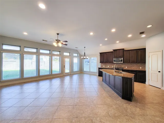 a large kitchen with stainless steel appliances lots of counter top space