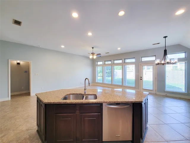 a kitchen with granite countertop a sink and a window