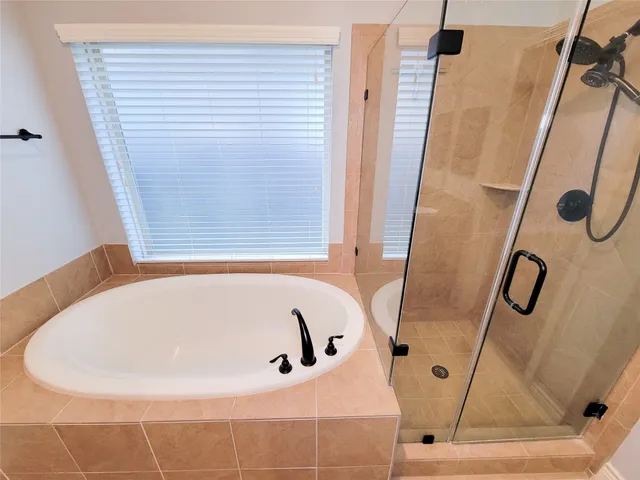 a bathroom with a tub and a shower