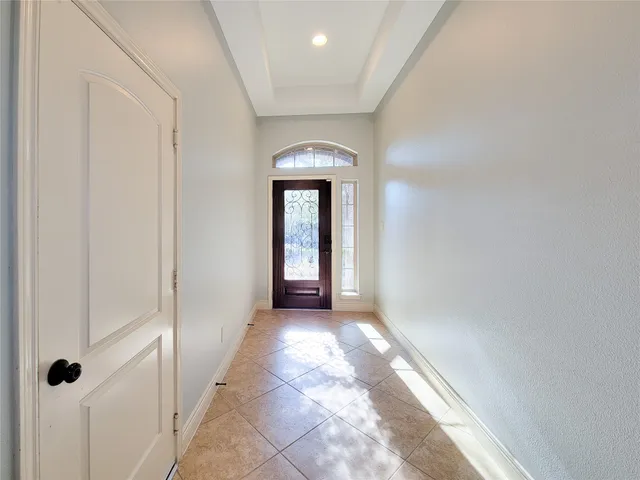 a view of a hallway with wooden floor and a carpet