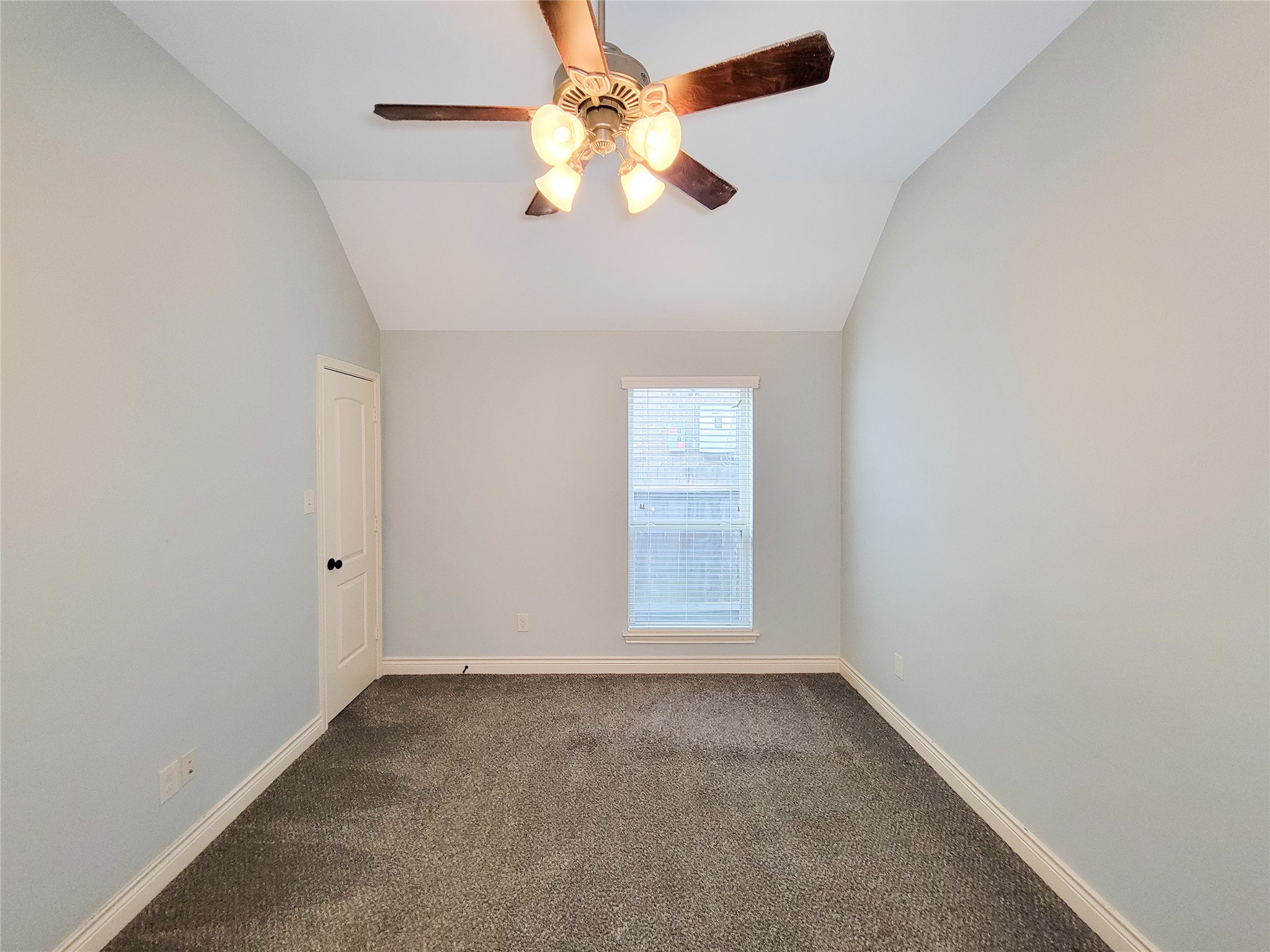 106 Colina Vista Way Montgomery, TX 77316 - Photo 8 of 29 an empty room with a chandelier fan and windows