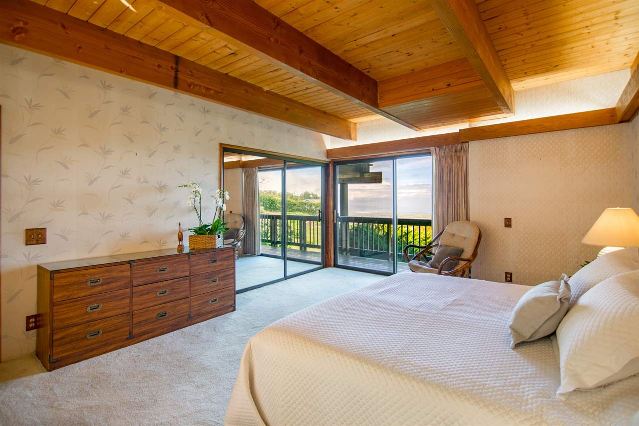 1470 Naalae Road Kula, HI 96790 - Photo 12 of 30 a bed room with a bed and a balcony