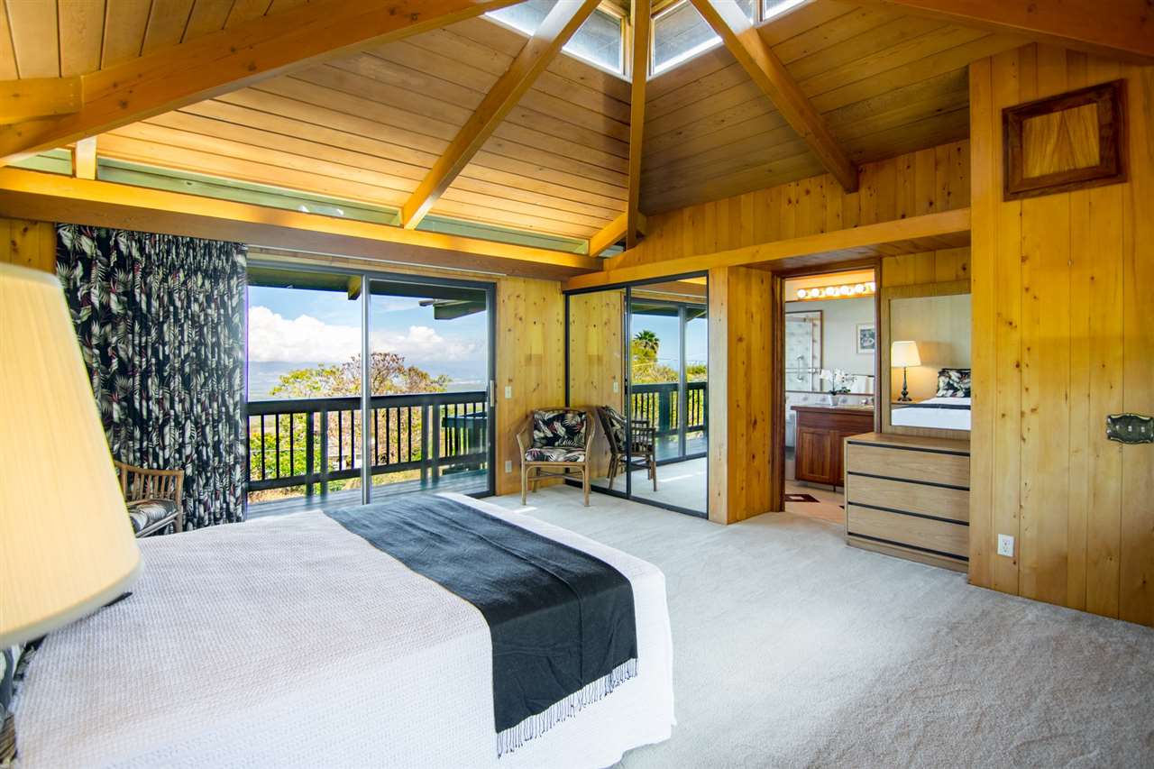 1470 Naalae Road Kula, HI 96790 - Photo 15 of 30 a bedroom with a bed and a large window