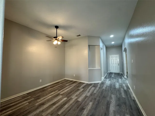 a kitchen with stainless steel appliances granite countertop a stove a sink dishwasher and a refrigerator with wooden floor