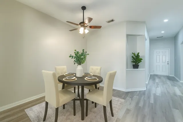 a living room with furniture kitchen view and a large window