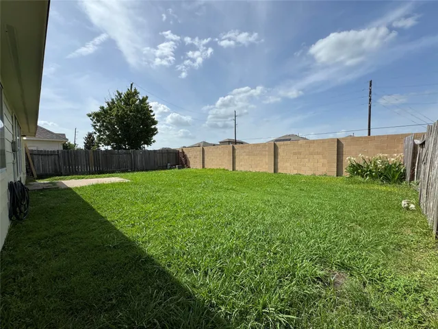 a yellow and red house with a garden