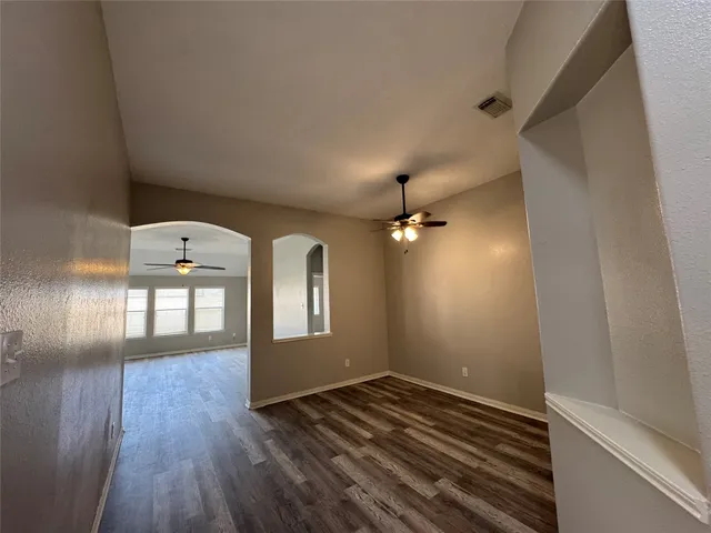 a view of a workspace with furniture and wooden floor
