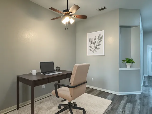 a view of a room with a ceiling fan a hardwood floor and a ceiling fan