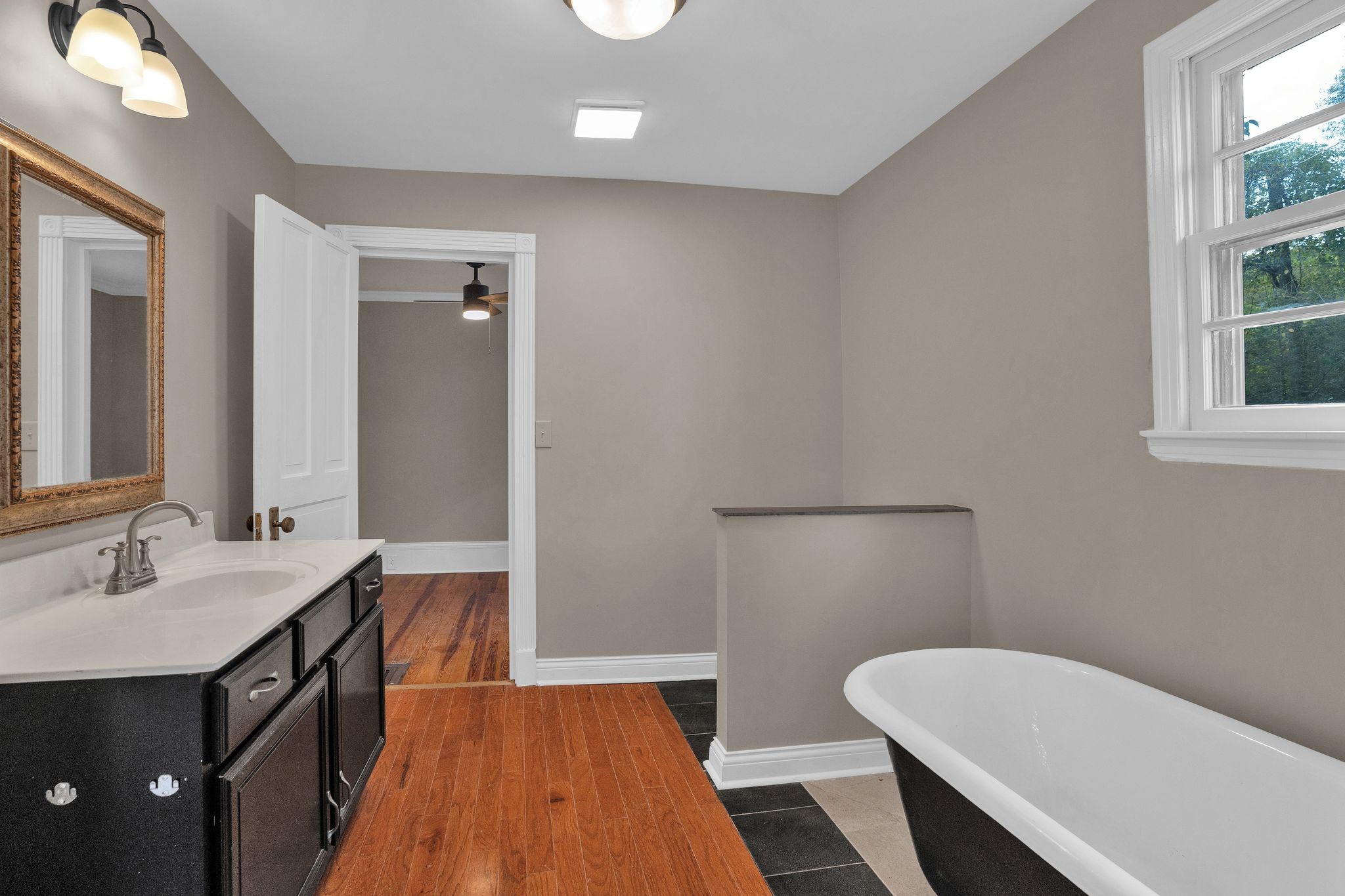 115 North Main Street Springfield, TN 37172 - Photo 19 of 34 a spacious bathroom with a double vanity sink a toilet and a mirror