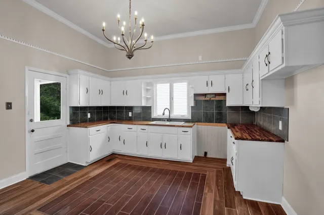 a kitchen with cabinets and wooden floor