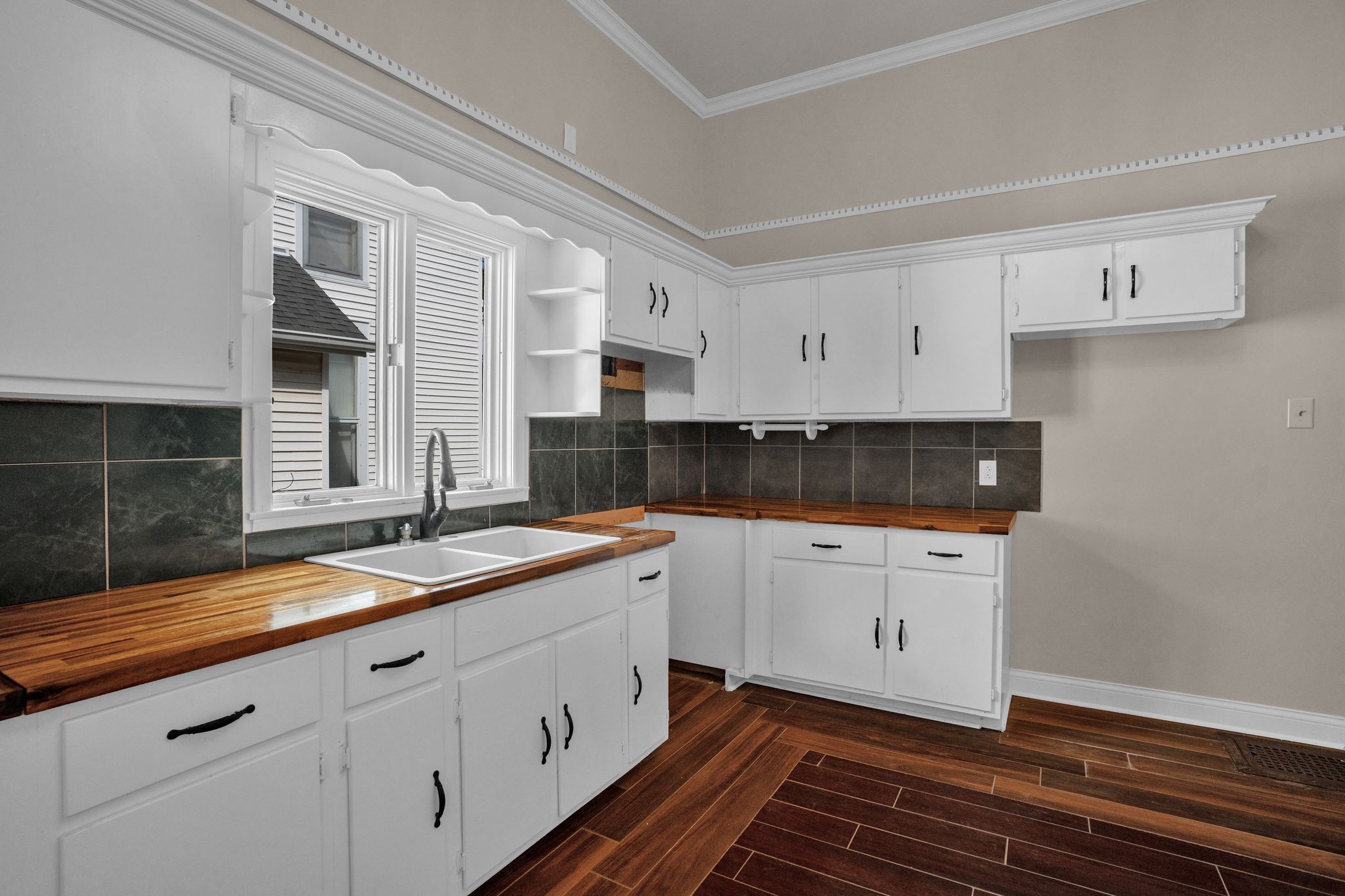 115 North Main Street Springfield, TN 37172 - Photo 22 of 34 a kitchen with granite countertop white cabinets and white appliances