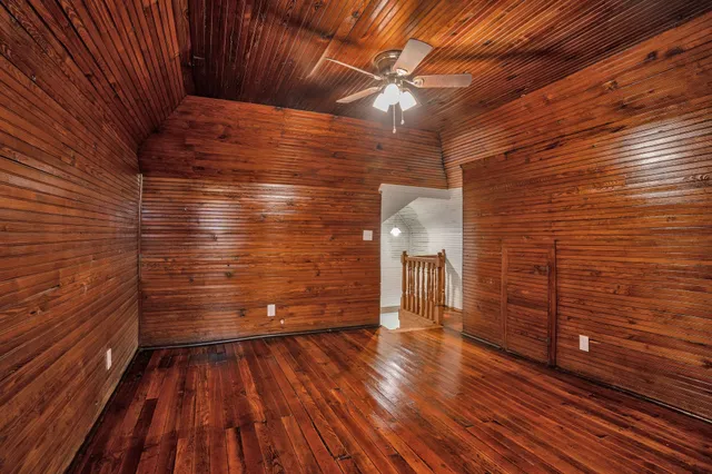 a view of an empty room with wooden floor