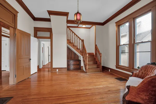 a view of entryway and hall with wooden floor