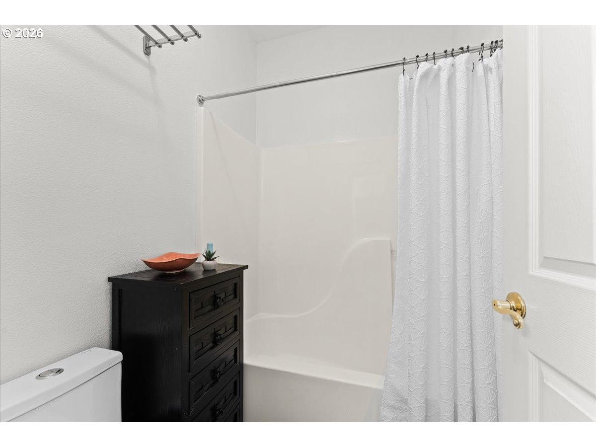 12431 Southwest 55th Place Portland, OR 97219 - Photo 20 of 40 a bathroom with a shower and a table