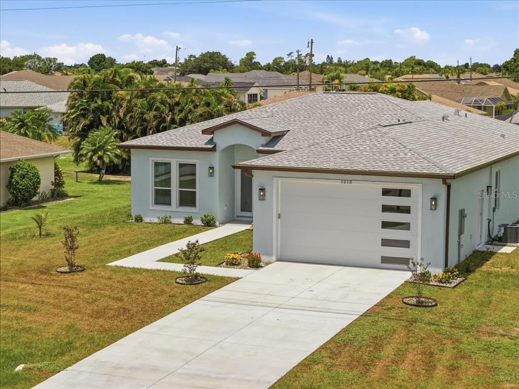 1215 Rio De Janeiro Avenue Punta Gorda, FL 33983 - Photo 64 of 65 a view of a house with swimming pool and a yard