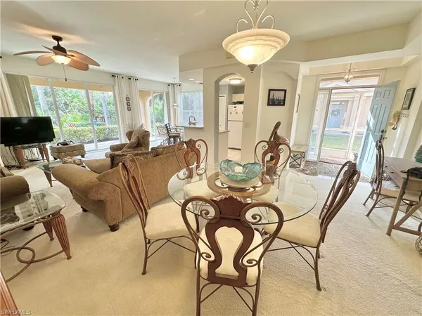 a view of a dining room with furniture and a chandelier