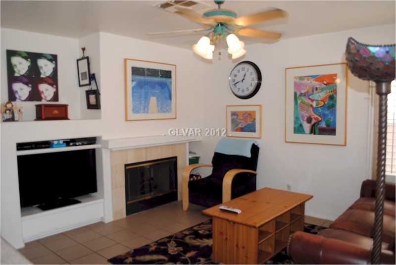 22 Rue De Parc Henderson, NV 89074 - Photo 11 of 32 Den. Family Room with fireplace, television nook, and ceiling fan.
