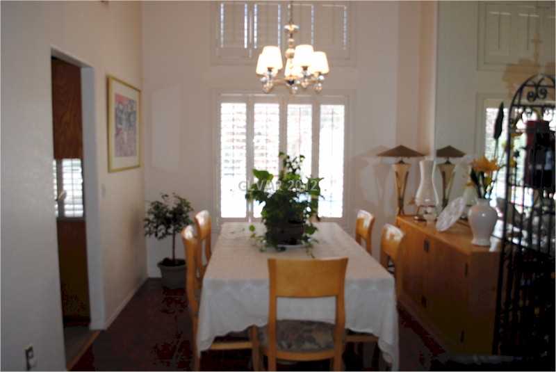 22 Rue De Parc Henderson, NV 89074 - Photo 13 of 32 Dining Room. Formal dining room with mirror and shutters.