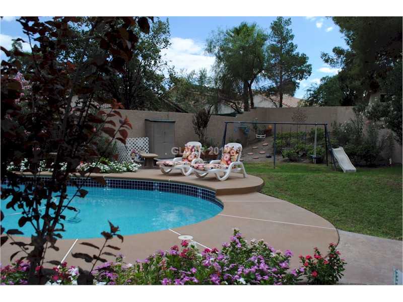 22 Rue De Parc Henderson, NV 89074 - Photo 7 of 32 Yard/Garden. Backyard with pool, green grass and playground.