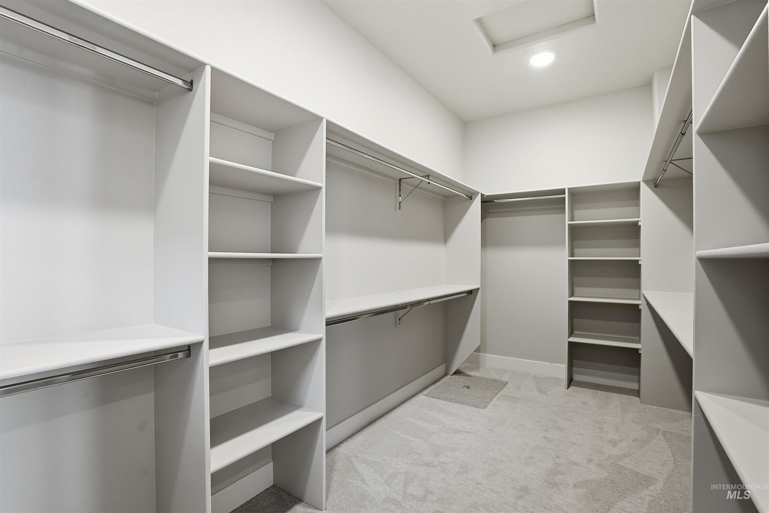 2976 East Parulo Drive Meridian, ID 83642 - Photo 23 of 40 Walk in closet with light colored carpet and attic access
