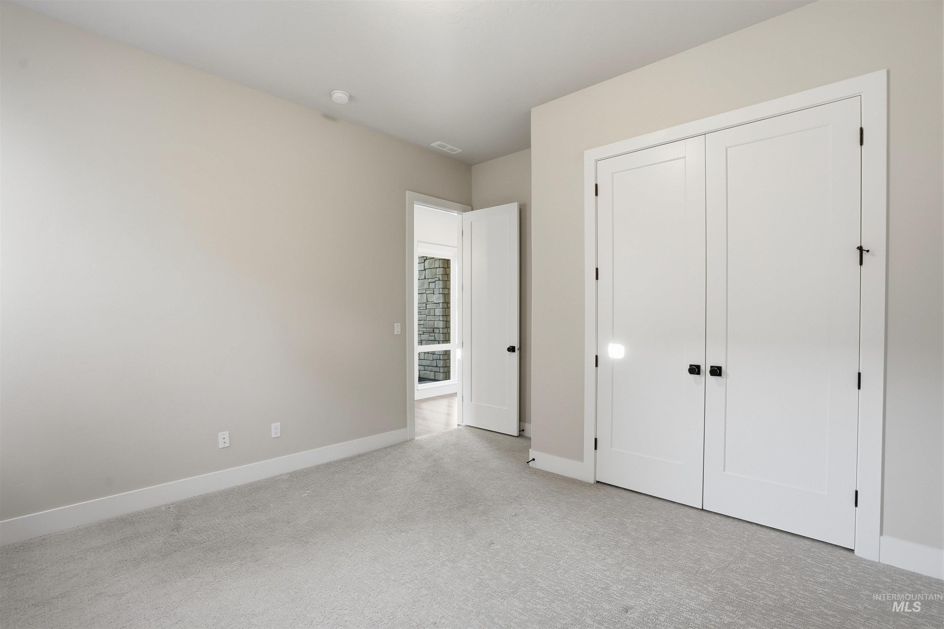 2976 East Parulo Drive Meridian, ID 83642 - Photo 28 of 40 Unfurnished bedroom with light carpet and a closet