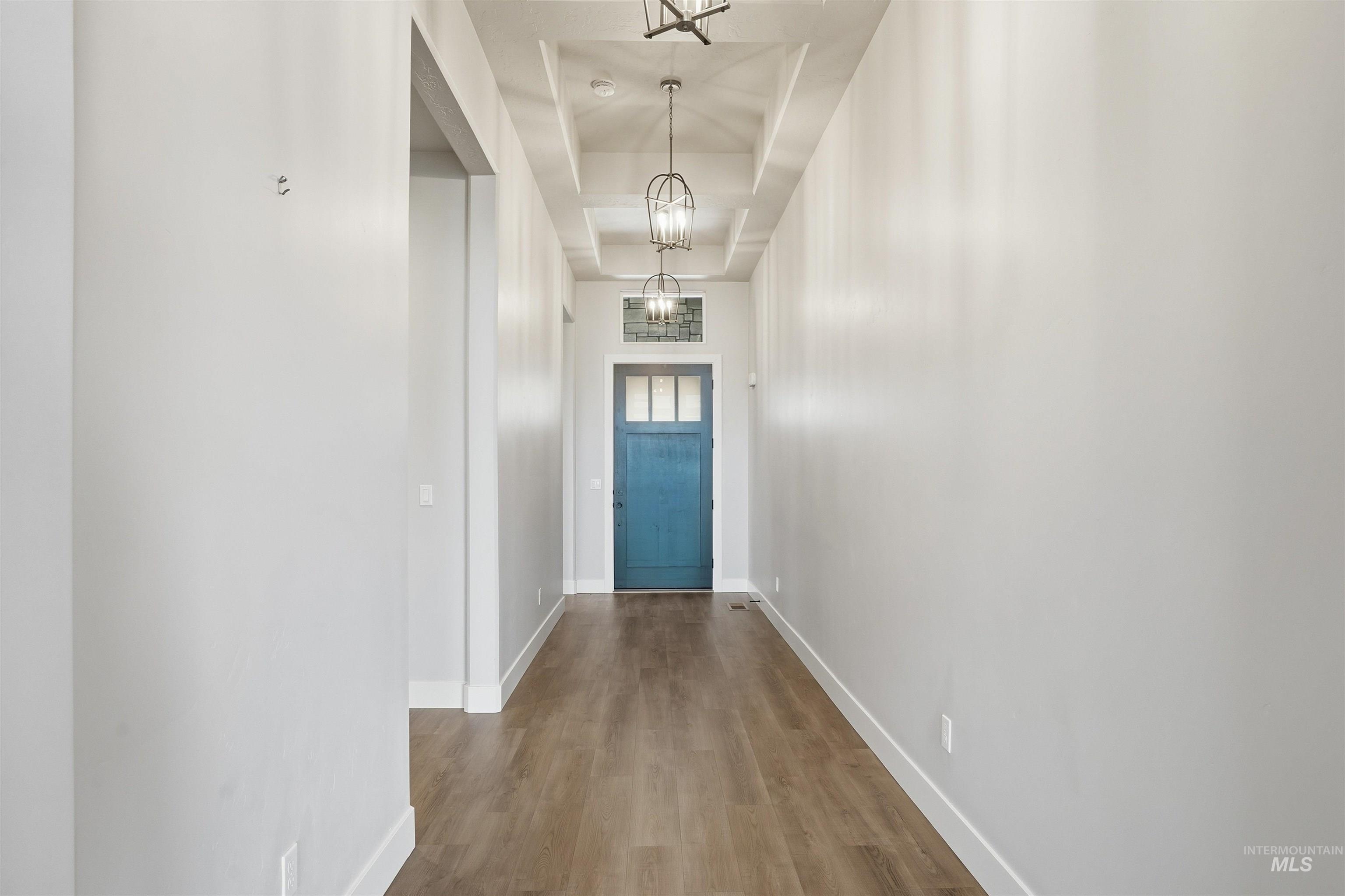 2976 East Parulo Drive Meridian, ID 83642 - Photo 5 of 40 Doorway to outside featuring wood finished floors and a raised ceiling