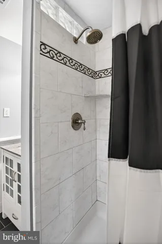 a bathroom with a shower and a mirror