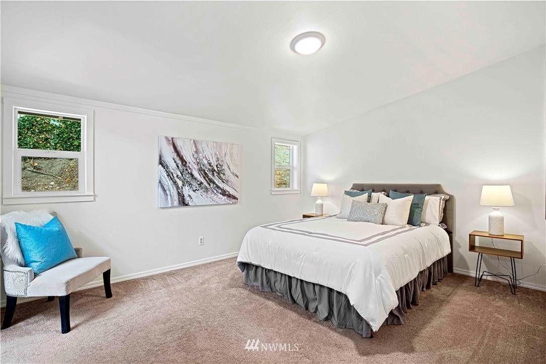 17415 Renton Issaquah Road Southeast Renton, WA 98059 - Photo 22 of 37 a spacious bedroom with a bed and a couch