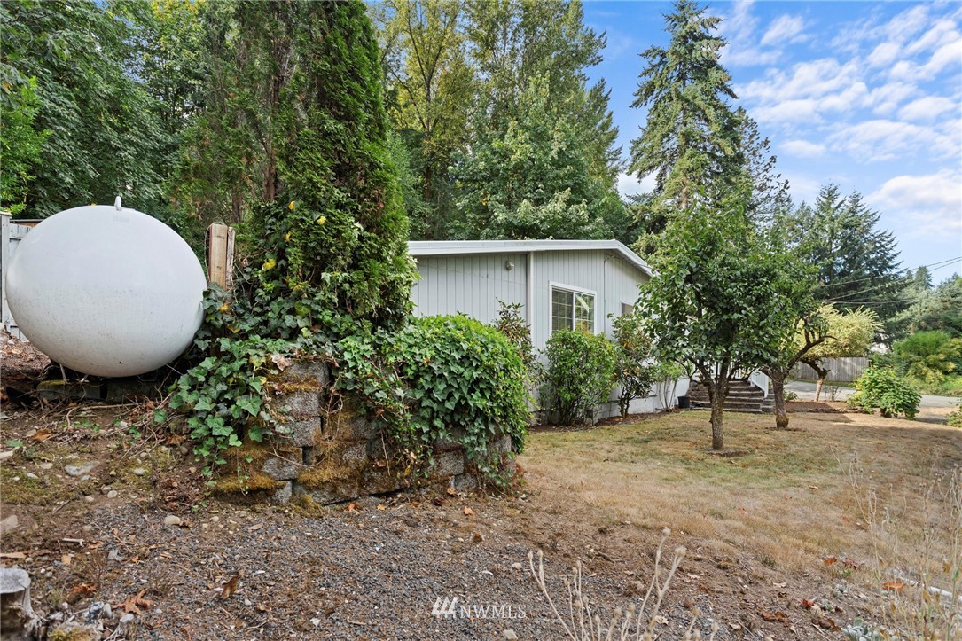 17415 Renton Issaquah Road Southeast Renton, WA 98059 - Photo 36 of 37 a view of a house with a yard and tree s