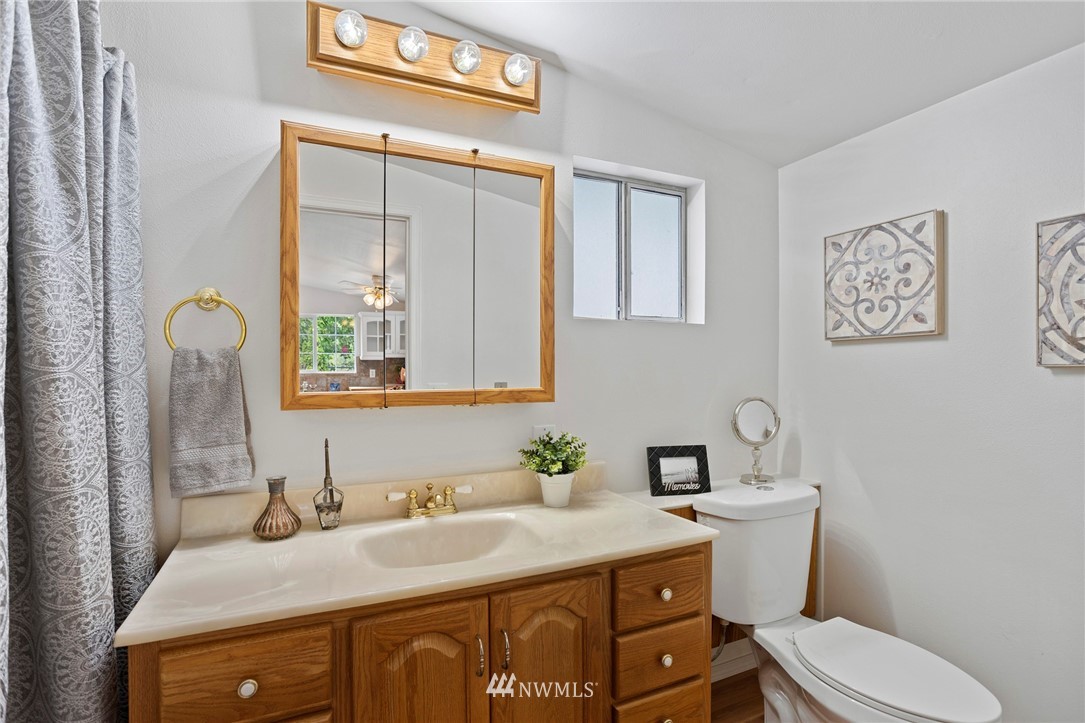 17415 Renton Issaquah Road Southeast Renton, WA 98059 - Photo 7 of 37 a bathroom with a granite countertop toilet sink and mirror