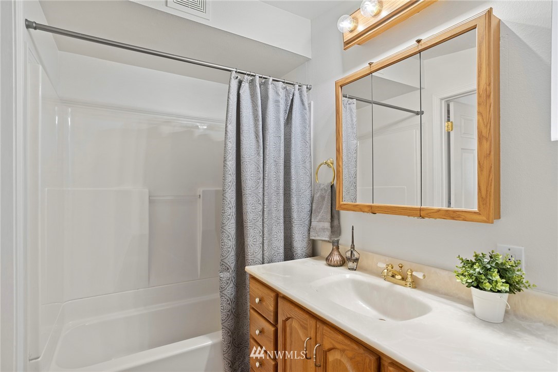 17415 Renton Issaquah Road Southeast Renton, WA 98059 - Photo 8 of 37 a bathroom with a granite countertop sink and a mirror