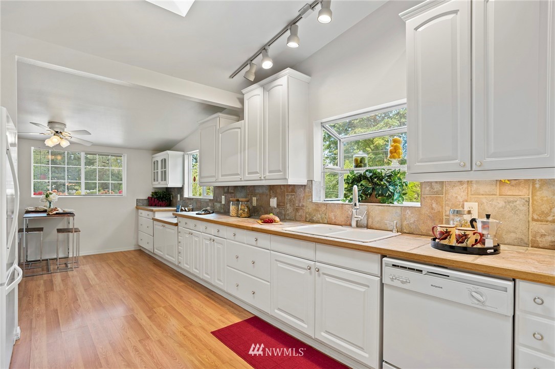 17415 Renton Issaquah Road Southeast Renton, WA 98059 - Photo 10 of 37 a kitchen with granite countertop white cabinets white appliances and sink
