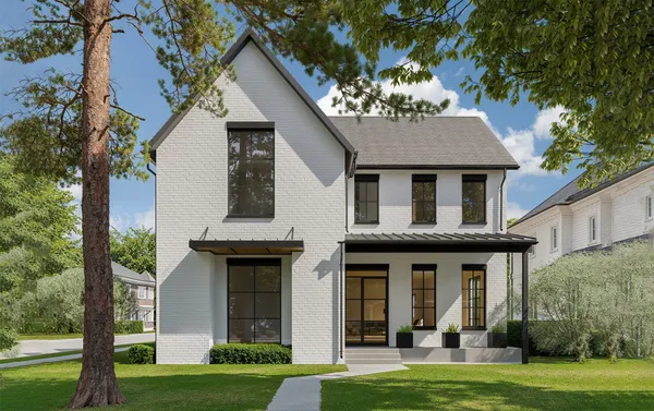 a view of a white house with a large windows and a yard with plants and large trees