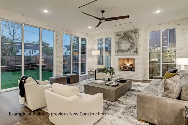 a living room with fireplace furniture and a large window