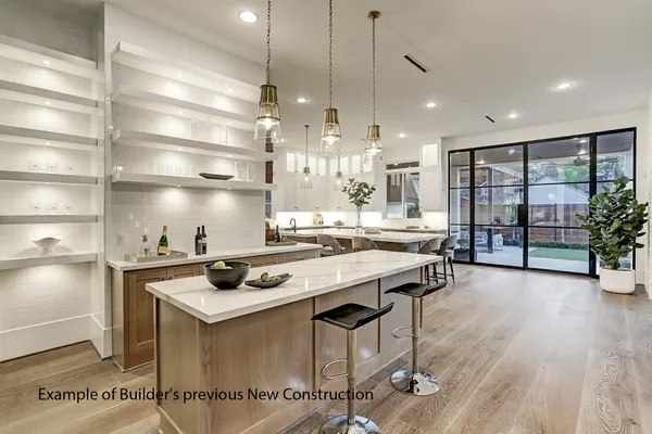 a room with stainless steel appliances kitchen island a large island in the center