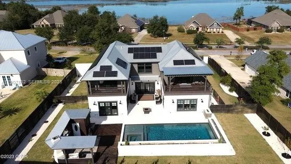 an aerial view of a house with a yard