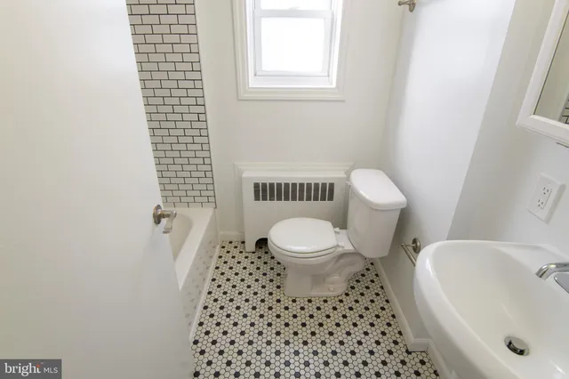 a bathroom with a toilet and a sink