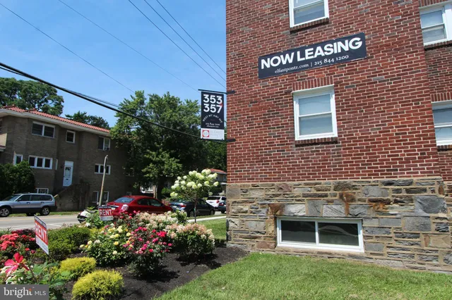 a view of a house with a yard and potted plants