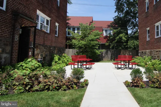 a view of a patio with table and chairs and potted plants