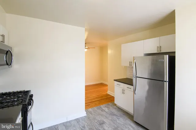 a white refrigerator freezer and a stove sitting inside of a kitchen